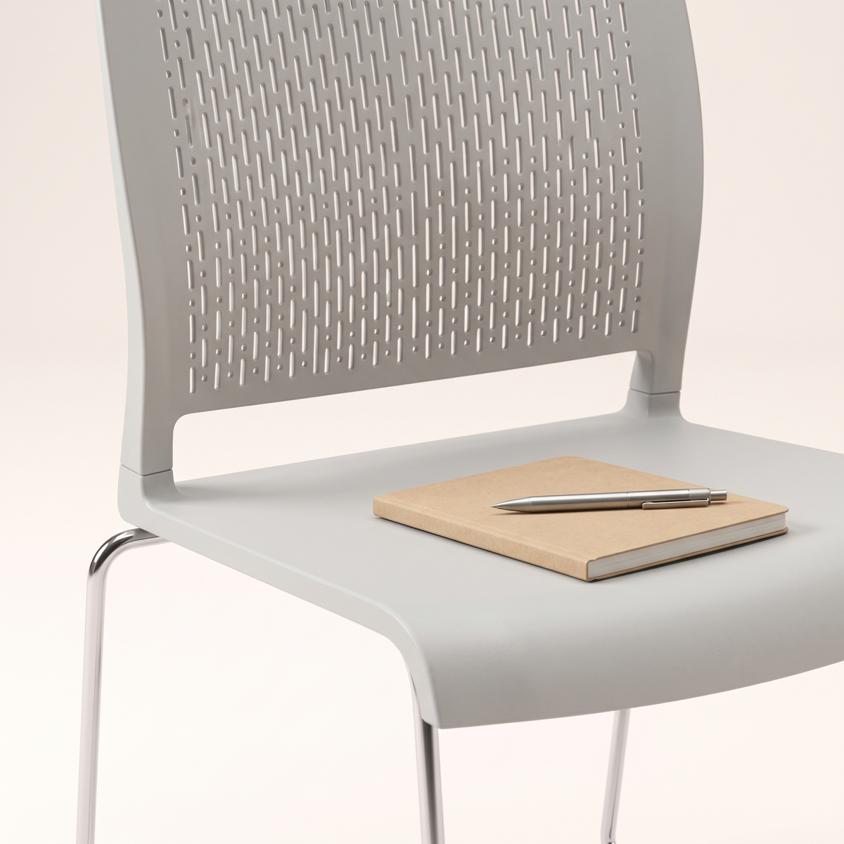Grey Perforated Visitor Chair with Chrome Sled Base, styled detail