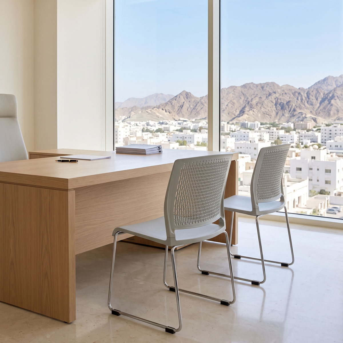 Grey Perforated Visitor Chair with Chrome Sled Base in a Muscat office