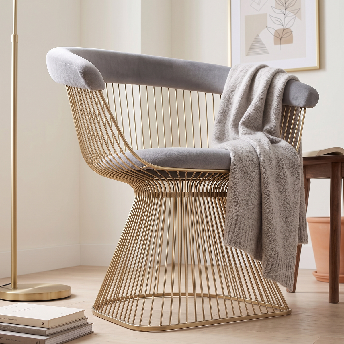 Low angled view of the Lounge Chair T006 with grey velvet seat and gold wire rods