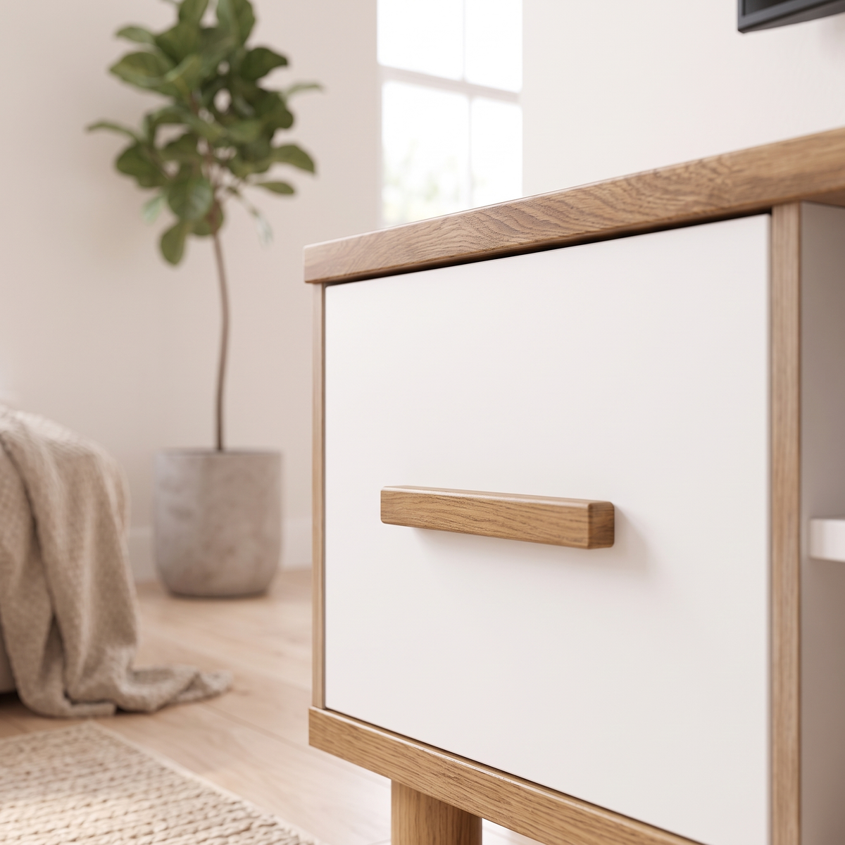 Close-up of a white drawer front with its wooden bar handle on the Cemre TV Stand