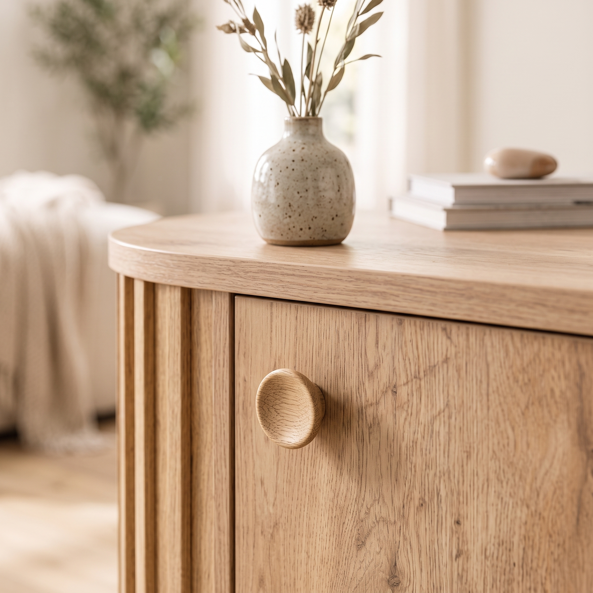 Detail of a round wooden knob on the Sedir cabinet door with a stoneware vase