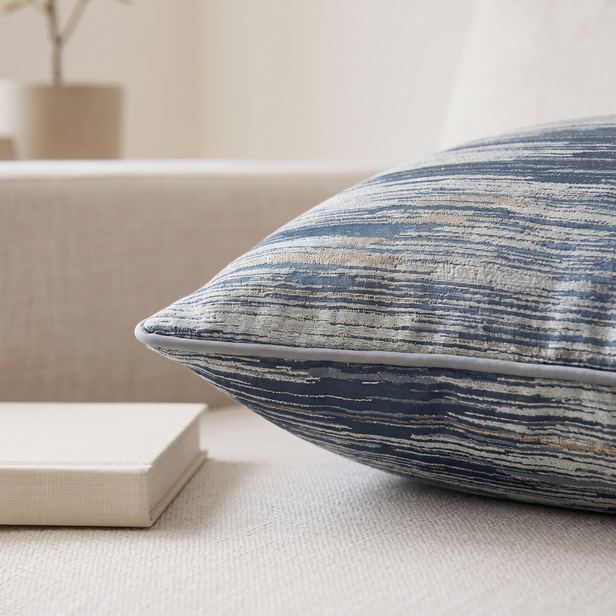 Detail of the piped cushion corner beside a small book