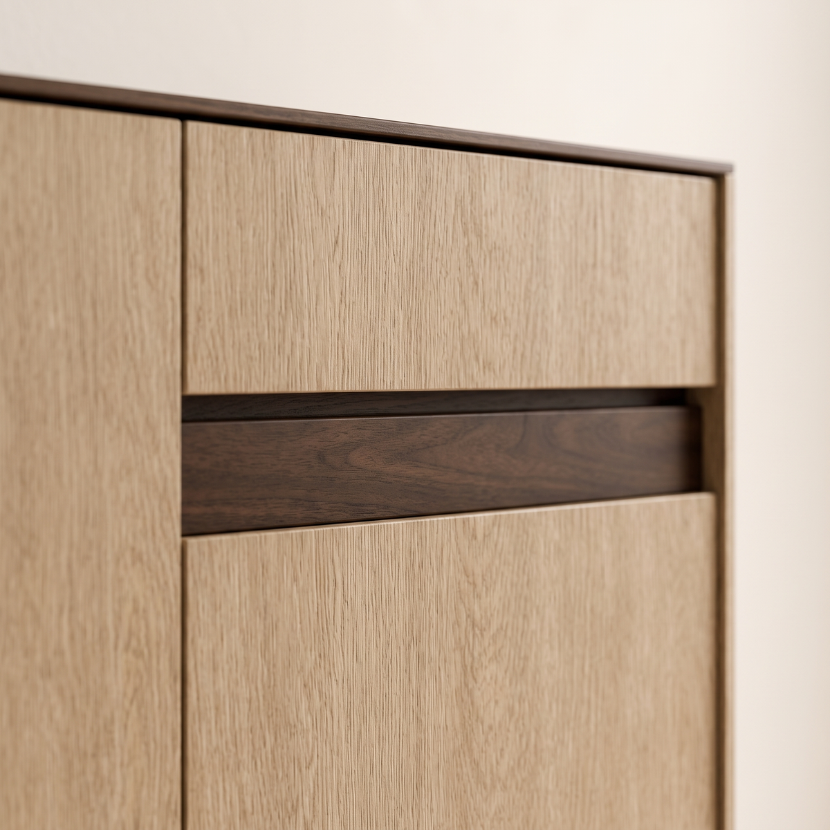 Detail of the recessed walnut pull strip between oak drawer and door