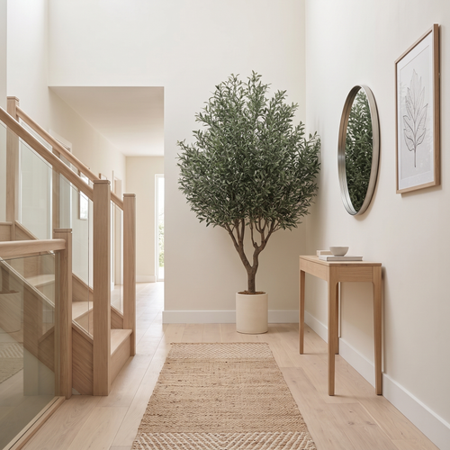 Artificial olive tree at the end of an entrance hallway beside the staircase