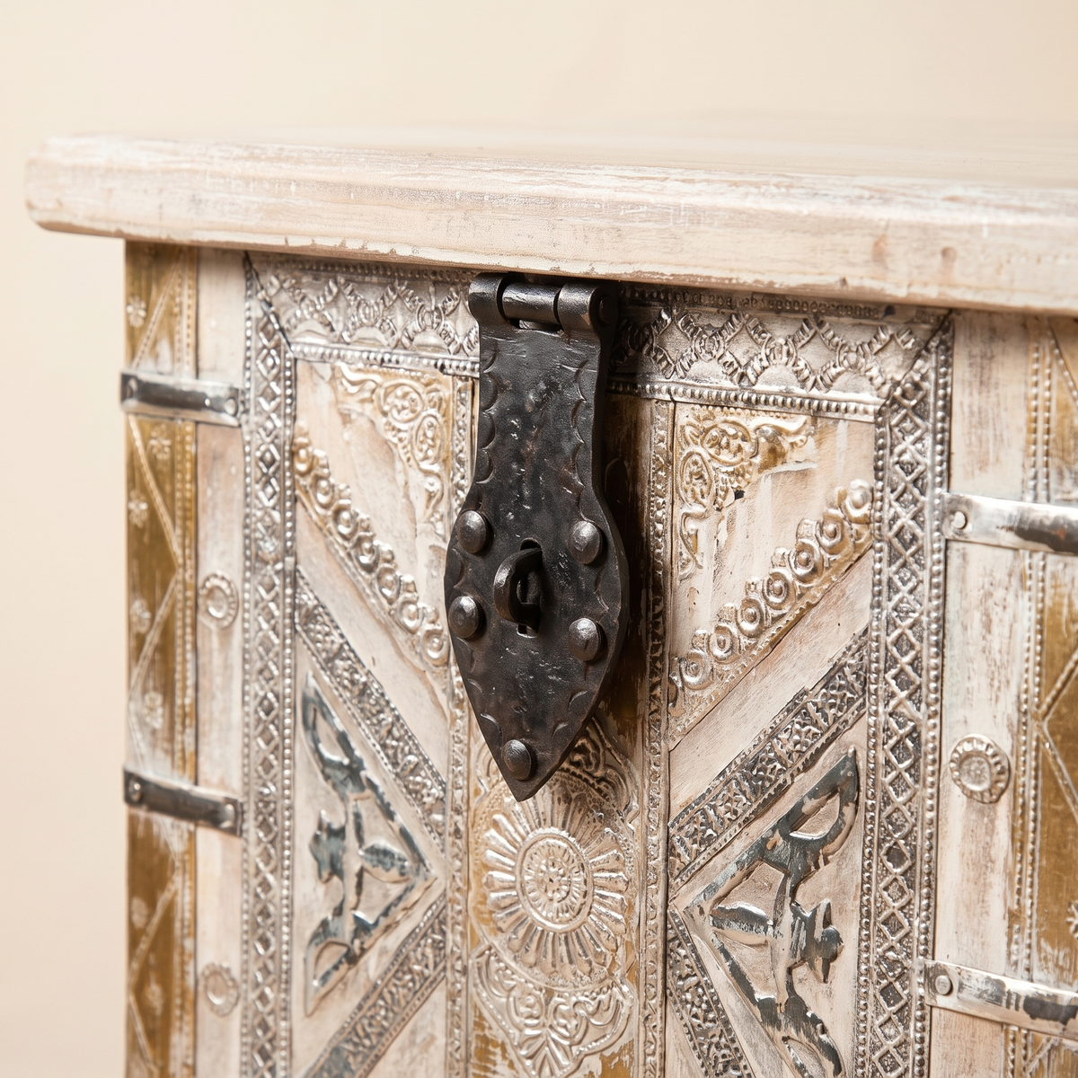 Detail of the black iron hasp and embossed silver-tone metal panels
