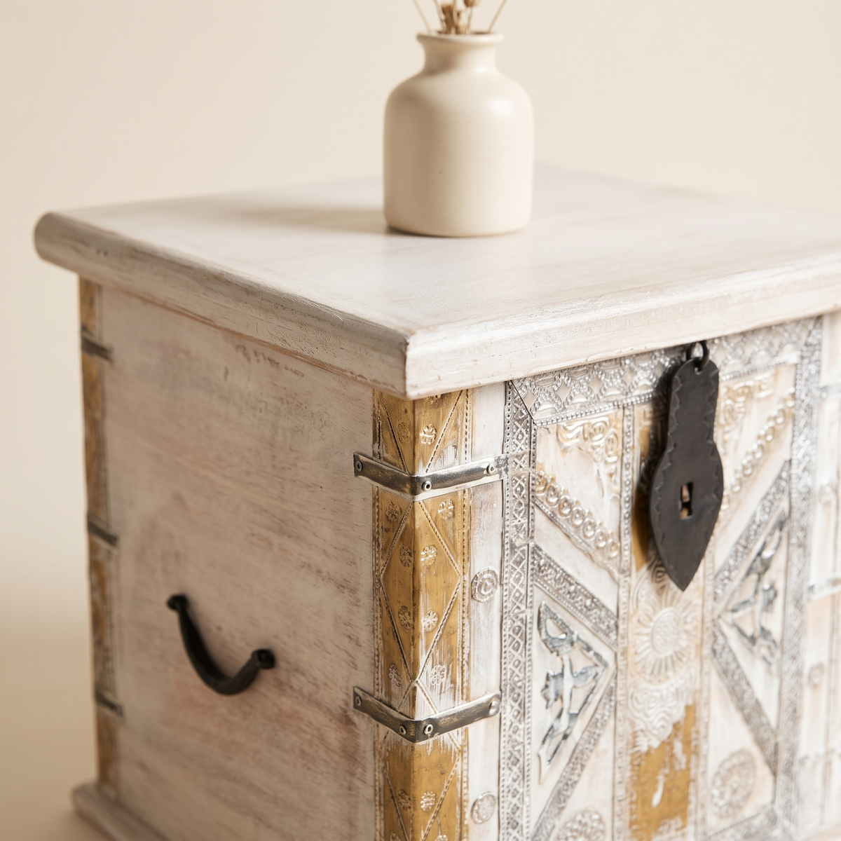 Whitewashed chest lid corner with brass strips, iron handle and a small vase