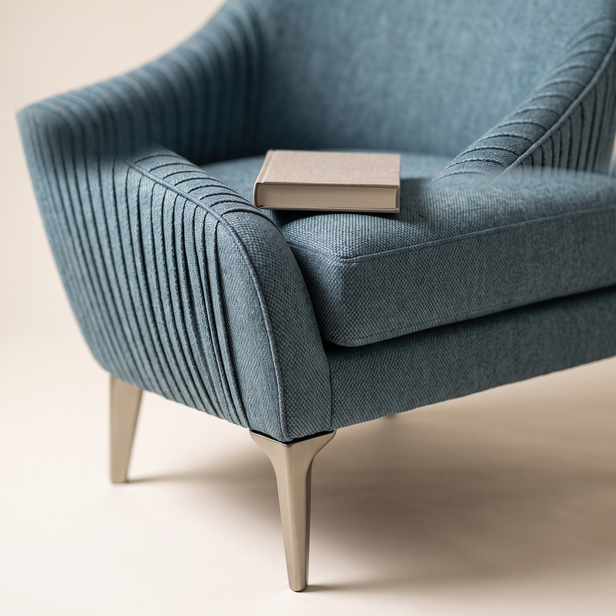 Stil armchair seat cushion and angled metal leg with a book