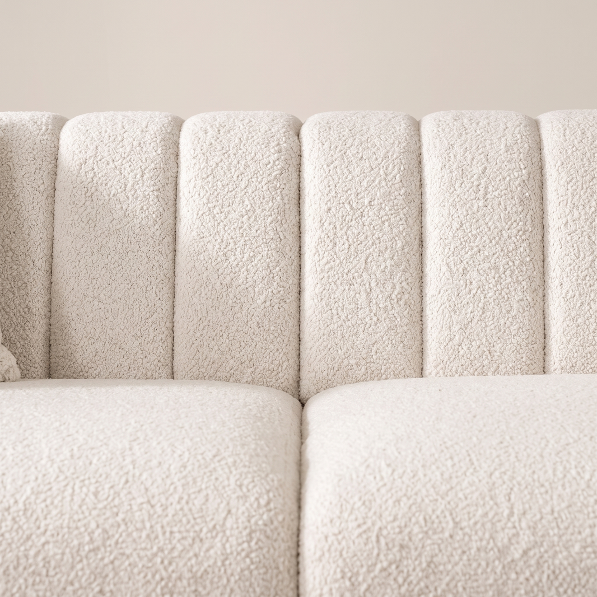 Detail of the vertically channelled ivory boucle backrest